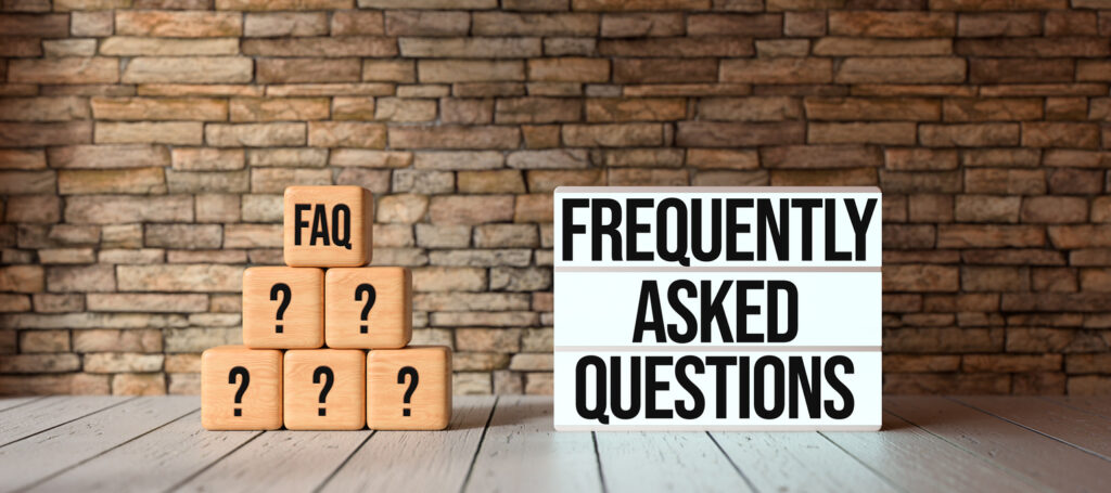 cubes with the abbreviation FAQ and lightbox with message FREQUENTLY ASKED QUESTIONS in front of a brick wall on wooden floor - 3D rendered illustration