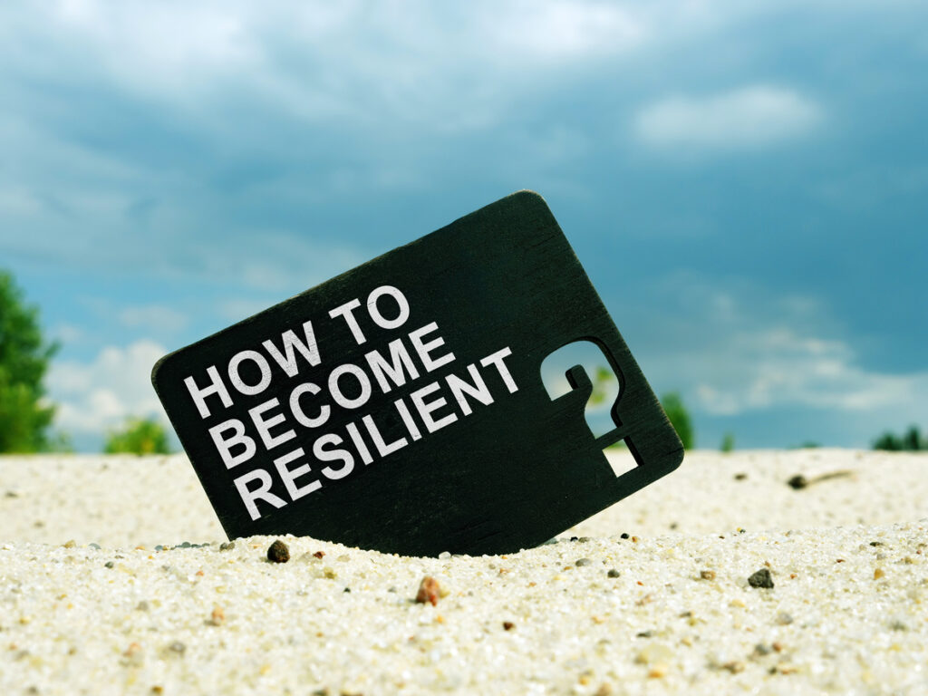 How to Become Resilient words on the black plate. Resilience concept.
